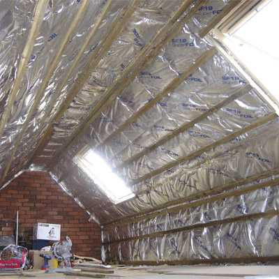 Loft room with exposed rafters and insulation